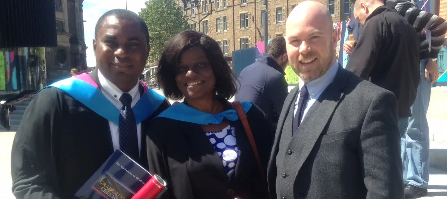 Photo of Dr Robin with two graduates