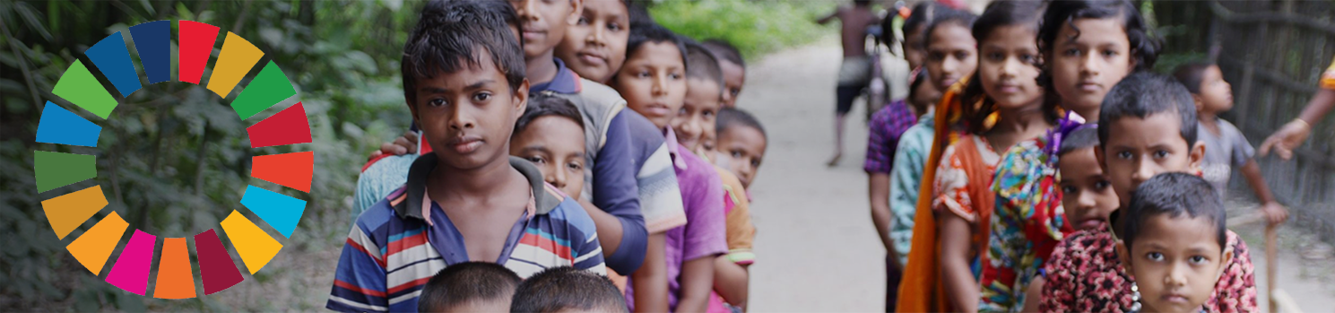 Children in lined up as boys and girls with the SDG ring of colours